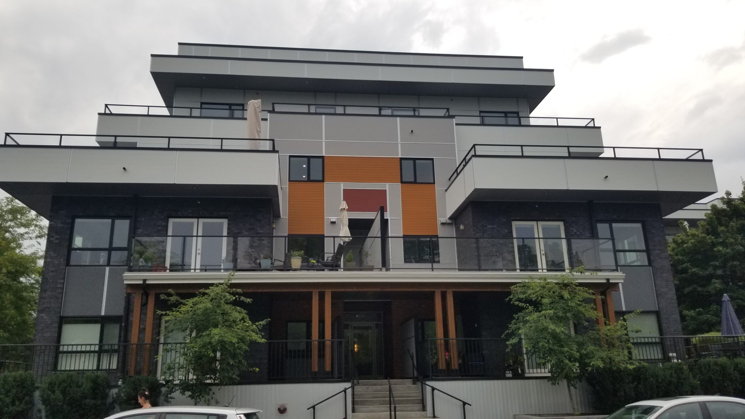 apartment-building-siding-kelowna Apartment building with grey and orange panel siding